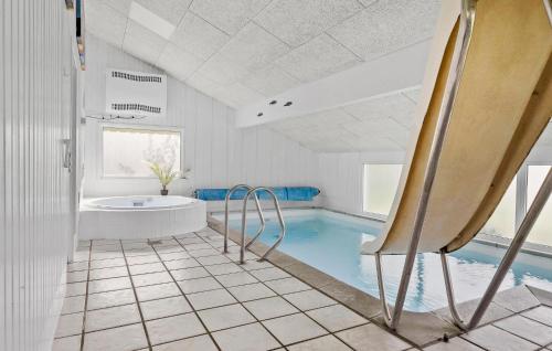 a bathroom with a tub and a bath tub at Nice Home In Sydals With Wifi in Høruphav