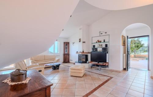 a living room with a couch and a tv at Nice Home In Imperia With Wifi in Imperia