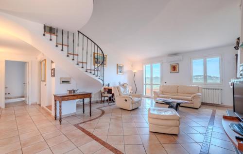 a living room with a staircase and a couch at Nice Home In Imperia With Wifi in Imperia