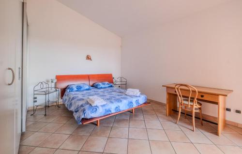 a bedroom with a bed and a desk and a table at Nice Home In Imperia With Wifi in Imperia