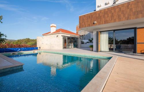 a swimming pool in the backyard of a house at Lovely Apartment In Rogoznica With Wifi in Rogoznica