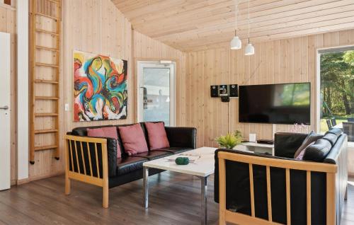 a living room with a couch and a table at Holiday Home Tværvænget Blåvand in Ho