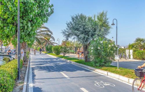 a street with trees and a bike lane at Albamare in Alba Adriatica