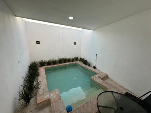 a large swimming pool in a white room at Villas Miland - San Benito Beach in San Benito