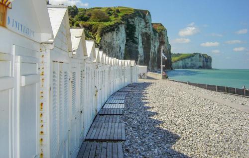 a white wall on a beach next to the ocean at 2 Bedroom Lovely Home In Bourville in Sainte-Colombe