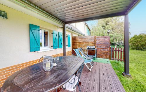 a wooden deck with a table and chairs at 2 Bedroom Lovely Home In Bourville in Sainte-Colombe