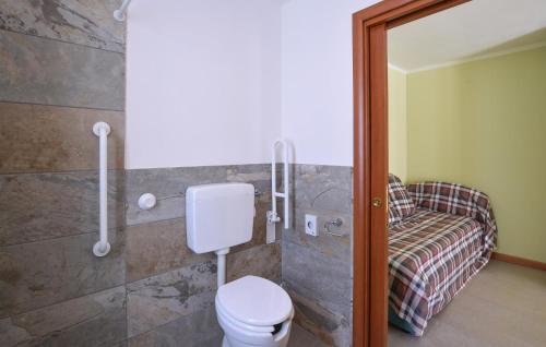 a bathroom with a toilet and a shower with a bench at Awesome Apartment In Pezzoro in Lavone