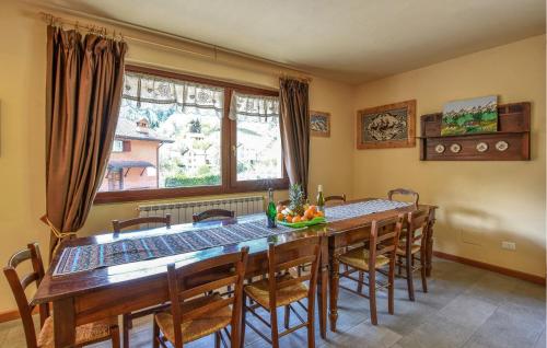 a dining room with a wooden table and chairs at Awesome Apartment In Pezzoro in Lavone