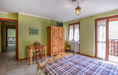 a bedroom with green walls and a bed and a table at Awesome Apartment In Pezzoro in Lavone