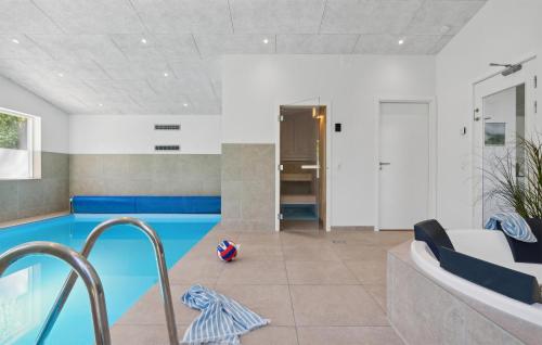 a living room with a pool and a soccer ball at Amazing Home In Vejby With Kitchen in Vejby