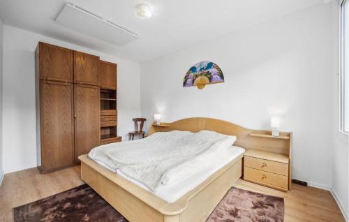 a bedroom with a bed and a wooden cabinet at Rheinblick in Kaub