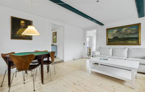 a living room with a table and a couch at Amazing Apartment In Tisvildeleje in Tisvildeleje