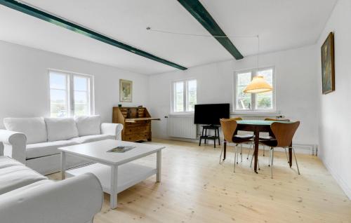 a living room with a white couch and a table at Amazing Apartment In Tisvildeleje in Tisvildeleje
