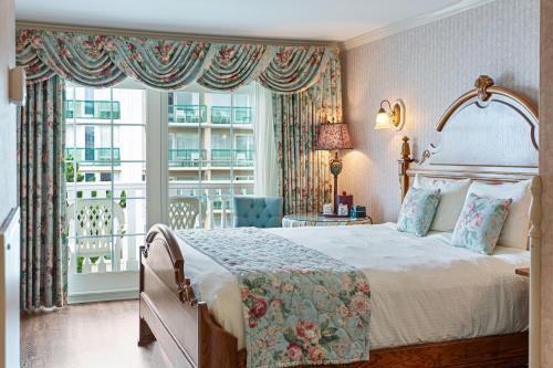 a bedroom with a bed and a large window at Boardwalk Plaza Hotel in Rehoboth Beach