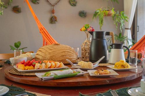 a table topped with plates of food on a table at Casa na Praia em Milagres - Casa Rudá in São Miguel dos Milagres