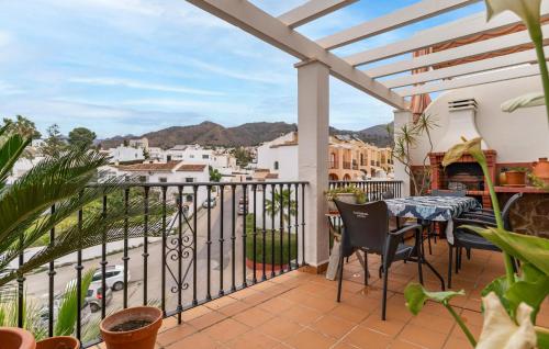 a patio with a table and chairs on a balcony at Beautiful Apartment In Nerja With Wifi in Nerja