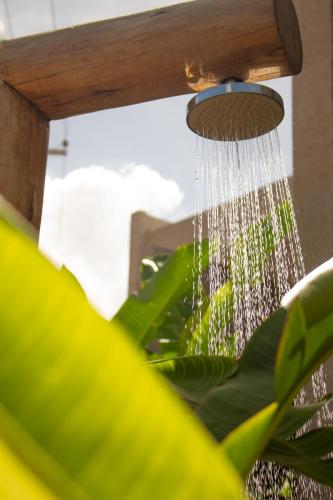 a drop of water hanging from a shower at Casa na Praia em Milagres - Casa Rudá in São Miguel dos Milagres
