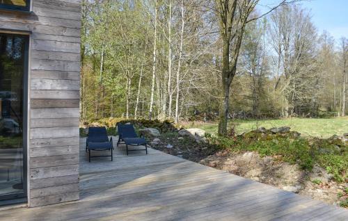 two blue chairs sitting on a wooden walkway at Amazing Home In Arkelstorp With Sauna in Arkelstorp