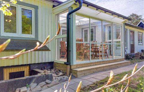 a screened in porch on a house with a patio at Beautiful Home In Båstad With Sauna in Båstad