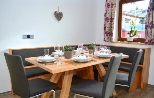 a wooden table with chairs and a dining room at Chalet In Mariapfarr in Mariapfarr