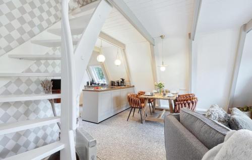 a living room with a couch and a table at Stunning Home In Friedrichskoog in Friedrichskoog