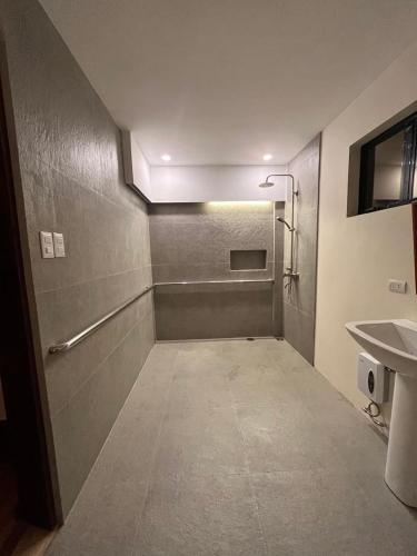 an empty bathroom with a sink and a shower at Tabularasa - T Palawan in San Vicente