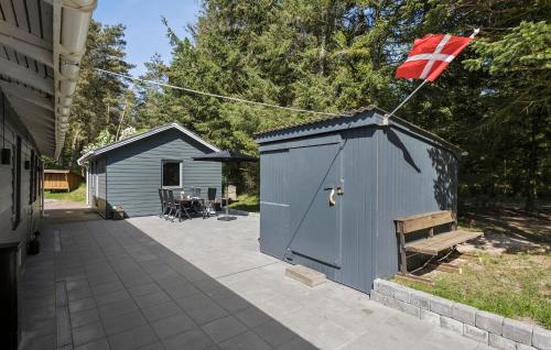 a blue shed with a flag on top of it at Amazing Home In Farsø With Wifi in Farsø