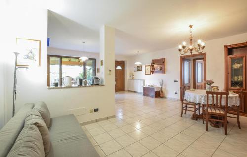 a living room with a couch and a table at Pet Friendly Home In Varallo Pombia in Varallo Pombia