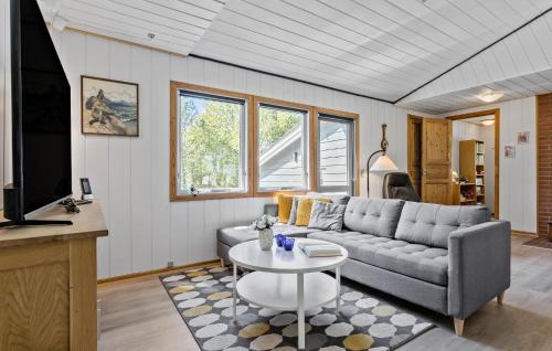 a living room with a couch and a table at Amazing Home In Farsø With Wifi in Farsø