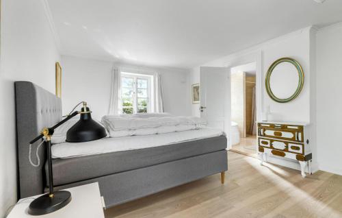 a bedroom with a bed with a desk and a mirror at Cozy Home In Gilleleje in Gilleleje