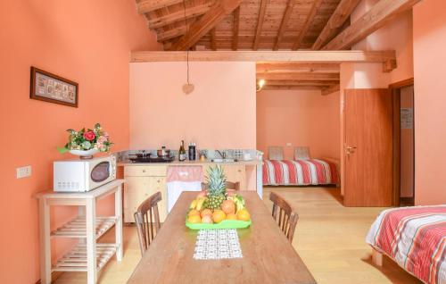 a kitchen with a table with a bowl of fruit on it at 2 Bedroom Stunning Apartment In Pezzoro in Lavone