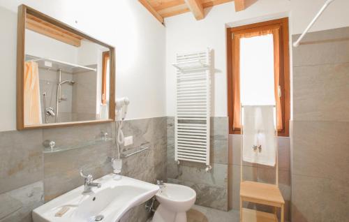 a bathroom with a sink and a toilet and a mirror at 2 Bedroom Stunning Apartment In Pezzoro in Lavone