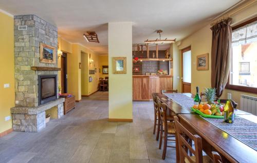 a kitchen and living room with a stone fireplace at 2 Bedroom Stunning Apartment In Pezzoro in Lavone