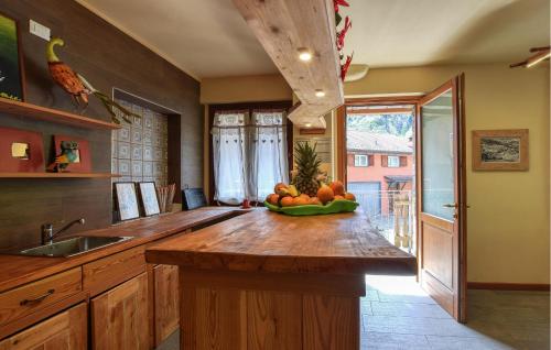 a kitchen with a counter with a bowl of fruit on it at 2 Bedroom Stunning Apartment In Pezzoro in Lavone