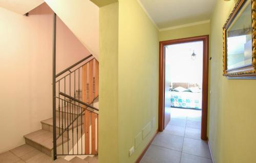 a hallway with a staircase with a mirror at 2 Bedroom Stunning Apartment In Pezzoro in Lavone