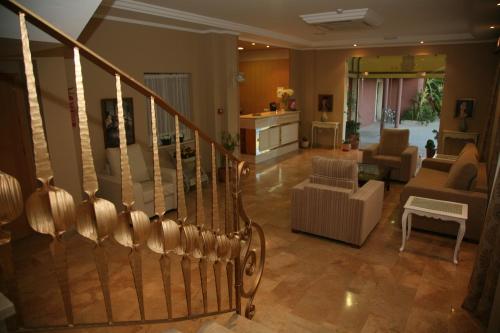 a living room filled with furniture and a staircase at Hotel Torre del Oro in La Rinconada