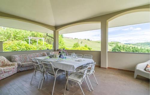 a dining room with a table and a couch at Villa Isabella in Agliano Terme