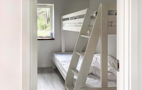 a white bunk bed in a room with a window at 3 Bedroom Cozy Home In Gotlands Tofta in Tofta
