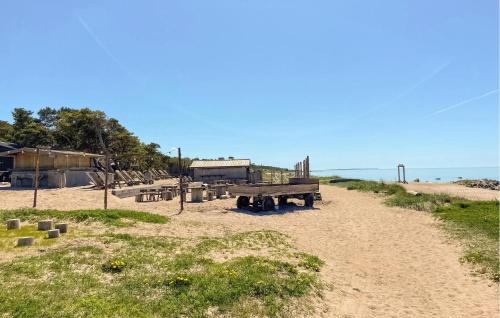 a picnic table on a sandy beach near the ocean at 3 Bedroom Cozy Home In Gotlands Tofta in Tofta