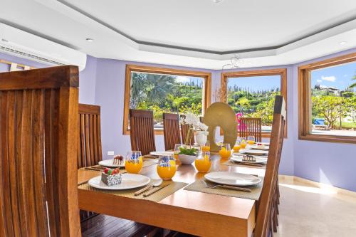 a dining room with a wooden table with plates and glasses at Wilderness Retreat-arubas Biggest Nature Hideaway in Santa Cruz