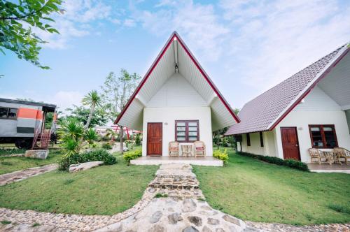 a white house with a gambrel roof at Tayama Farm Khaoyai in Nakhon Ratchasima