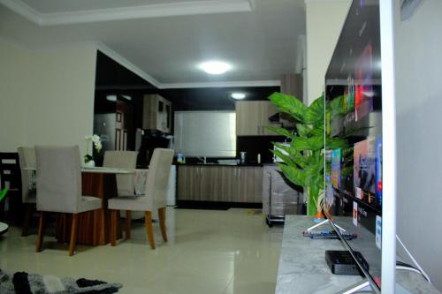 a kitchen and dining room with a table and chairs at Your home away from home in Lusaka