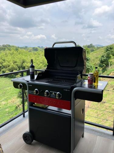 a barbecue grill on a deck with a view at Maranatha. Grotto & Boutique+Hydrotherapy in Pereira