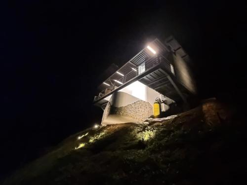 a light on top of a building at night at Maranatha. Grotto & Boutique+Hydrotherapy in Pereira