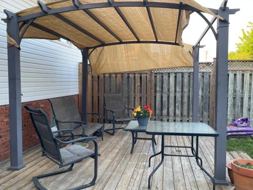 a gazebo with chairs and a table on a deck at Private Suite in Niagara Falls in Niagara Falls