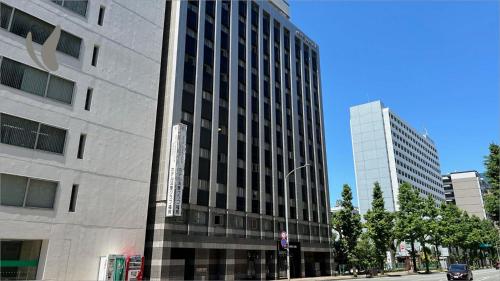 a tall building on the side of a street at Hotel Hokke Club Fukuoka in Fukuoka
