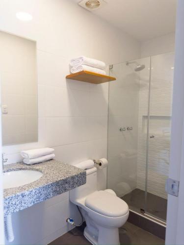 a bathroom with a toilet and a sink and a shower at Hotel Casa costa in Mollendo