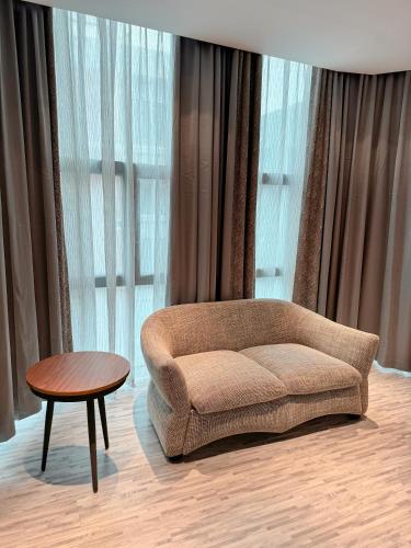 a living room with a couch and a table at Hotel Omni Residency Baridhara in Dhaka
