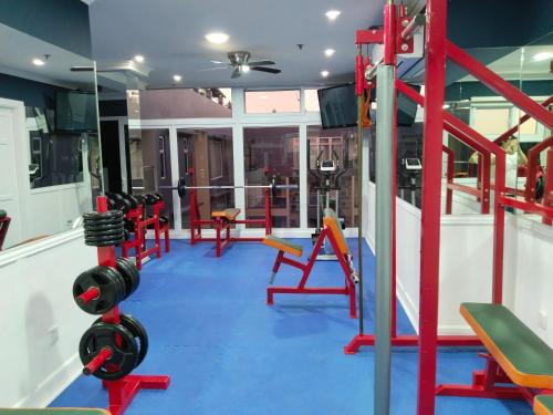 a gym with dumbbells and equipment in a room at Luxurious Penthouse La Grande Résidence with Home Theater & Netflix in Angeles