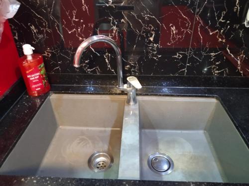 a sink with a faucet in a kitchen at Luxurious Penthouse La Grande Résidence with Home Theater & Netflix in Angeles